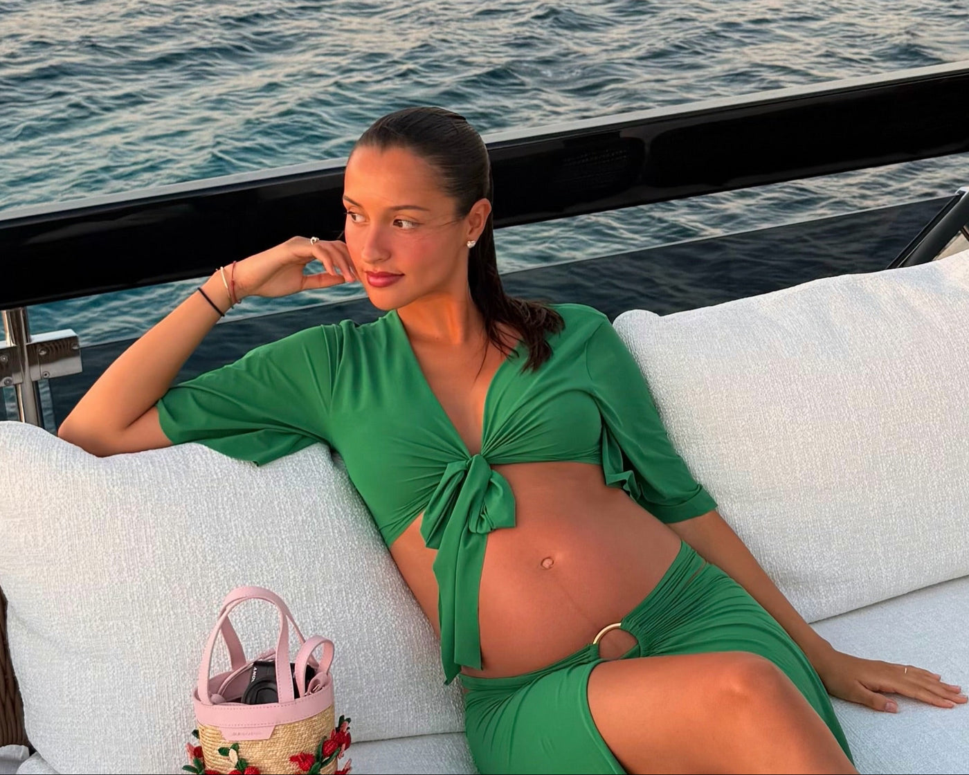 Alexandra Leclerc, Sardinia. Green tie-front set, raffia bucket bag, low ponytail, diamond studs. Image via Instagram.