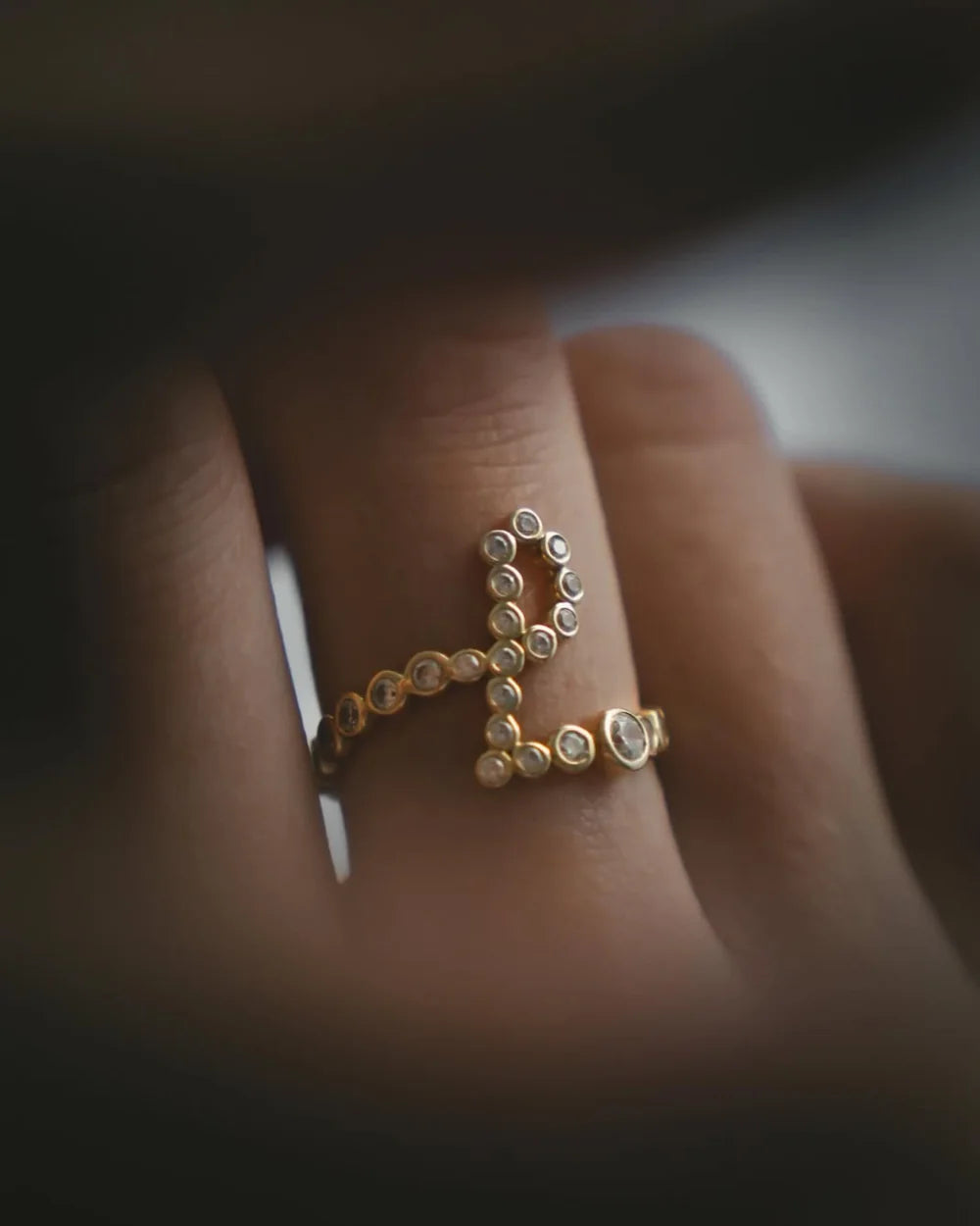  The Signature Pavé Initial Ring — graduated stones, two millimetres to three, bezel-set by hand.